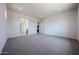 A large bedroom with neutral walls and carpeting, and access to a full bathroom at 1101 E Dolores Rd, Phoenix, AZ 85086