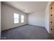Spacious bedroom with plush carpeting, neutral paint, and bright natural light at 1101 E Dolores Rd, Phoenix, AZ 85086
