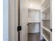 A view of an organized walk-in closet space featuring built-in shelving and hanging rods, perfect for storage at 1101 E Dolores Rd, Phoenix, AZ 85086