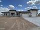 Charming single-story home featuring a neutral stucco finish, gray stone accents, and a spacious three-car garage at 1101 E Dolores Rd, Phoenix, AZ 85086