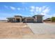 A modern single-story home with a spacious driveway and desert landscaping under a bright blue sky at 1101 E Dolores Rd, Phoenix, AZ 85086