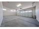 Spacious three car garage with white walls and concrete flooring offering ample parking and storage at 1101 E Dolores Rd, Phoenix, AZ 85086