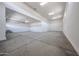 Spacious three car garage with white walls and concrete flooring offering ample parking and storage at 1101 E Dolores Rd, Phoenix, AZ 85086