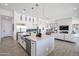 Open concept kitchen with large island, stainless steel appliances, and white cabinetry at 1101 E Dolores Rd, Phoenix, AZ 85086