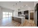 Well-lit kitchen with a center island, stainless steel appliances, and sliding glass doors to the patio at 1101 E Dolores Rd, Phoenix, AZ 85086