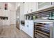 Modern kitchen with wine cooler, white cabinets, and stainless steel appliances at 1101 E Dolores Rd, Phoenix, AZ 85086