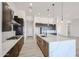 Modern kitchen with white backsplash, stainless steel appliances, and a center island at 1101 E Dolores Rd, Phoenix, AZ 85086
