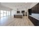 Bright, open-concept kitchen with modern cabinetry, a large island, and access to the living area at 1101 E Dolores Rd, Phoenix, AZ 85086