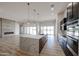 Open kitchen with large island, stainless steel appliances, and a view of the living space at 1101 E Dolores Rd, Phoenix, AZ 85086