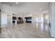 Open floor plan featuring modern kitchen with an island and a living room with wood-look tile floors at 1101 E Dolores Rd, Phoenix, AZ 85086