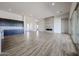 Bright living room featuring an elegant fireplace, wood-look tile floors, and recessed lighting at 1101 E Dolores Rd, Phoenix, AZ 85086