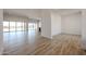 Open-concept living space with wood-look flooring, large windows, and seamless indoor/outdoor flow at 1101 E Dolores Rd, Phoenix, AZ 85086