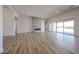 Bright living room with fireplace, wood-look tile floors, and large sliding glass door at 1101 E Dolores Rd, Phoenix, AZ 85086