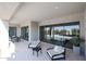 Outdoor patio with seating area, offering views of the pool and surrounding landscape at 1101 E Dolores Rd, Phoenix, AZ 85086