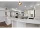 Elegant curved kitchen island with white cabinets and quartz countertops at 8320 E Quill St, Mesa, AZ 85207