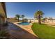 Stunning kidney shaped pool with palm trees and mountain views at 8320 E Quill St, Mesa, AZ 85207