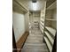 Large walk-in closet with ample shelving and bench at 1091 N 84Th Pl, Scottsdale, AZ 85257