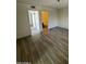 Open living area with wood-look floors, hallway, and bathroom access at 1091 N 84Th Pl, Scottsdale, AZ 85257