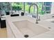 Island features a large sink, modern faucet, marble countertop and view to outside patio at 7127 E Rancho Vista Dr # 4012, Scottsdale, AZ 85251