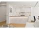 Open-concept kitchen featuring white cabinetry, marble countertops, and modern appliances at 7127 E Rancho Vista Dr # 4012, Scottsdale, AZ 85251