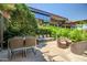 Private patio with dining table, lounge chairs, and lush landscaping, perfect for outdoor entertaining at 7127 E Rancho Vista Dr # 4012, Scottsdale, AZ 85251