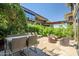 Private patio with dining table, lounge chairs, and lush landscaping, perfect for outdoor entertaining at 7127 E Rancho Vista Dr # 4012, Scottsdale, AZ 85251