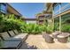 Private patio with dining table, lounge chairs, and lush landscaping, perfect for outdoor entertaining at 7127 E Rancho Vista Dr # 4012, Scottsdale, AZ 85251