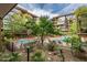 Inviting pool area surrounded by lush landscaping, orange lounge chairs, and modern architecture creating a relaxing ambiance at 7127 E Rancho Vista Dr # 4012, Scottsdale, AZ 85251
