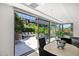 Bright sunroom with floor-to-ceiling windows offering views of a beautifully landscaped patio at 7127 E Rancho Vista Dr # 4012, Scottsdale, AZ 85251