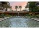 Charming courtyard with a tranquil water feature, palm trees, and meticulously landscaped gardens for peaceful living at 7127 E Rancho Vista Dr # 4012, Scottsdale, AZ 85251