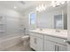 Bright bathroom with dual sinks, shower-tub combo, and updated fixtures at 17632 W Oregon Ave, Litchfield Park, AZ 85340