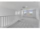 Upstairs hallway with windows, staircase, and carpeted flooring at 17632 W Oregon Ave, Litchfield Park, AZ 85340