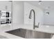 Close-up of a stainless steel kitchen sink with a modern faucet and quartz countertops at 17632 W Oregon Ave, Litchfield Park, AZ 85340