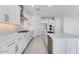 Contemporary kitchen showcasing white cabinets, quartz countertops, and stainless steel appliances at 17632 W Oregon Ave, Litchfield Park, AZ 85340