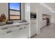 Modern kitchen with sleek cabinetry and a large window at 24863 N 103Rd N Way, Scottsdale, AZ 85255