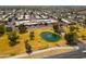 Aerial view of community featuring homes, landscaping, and a pond at 7917 E Bonnie Rose Ave, Scottsdale, AZ 85250