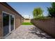 Small grassy backyard with brick wall and patio at 7917 E Bonnie Rose Ave, Scottsdale, AZ 85250