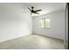 Bright bedroom with ceiling fan and large window at 7917 E Bonnie Rose Ave, Scottsdale, AZ 85250