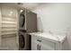 Laundry room with stacked washer/dryer and white cabinets at 7917 E Bonnie Rose Ave, Scottsdale, AZ 85250