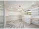 Bright walk-in closet with herringbone flooring and custom shelving at 7917 E Bonnie Rose Ave, Scottsdale, AZ 85250