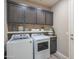 Laundry room with washer, dryer, and dark wood cabinets at 17983 E Vista Desierto --, Rio Verde, AZ 85263