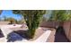 Backyard with curved walkway, gravel, and a tree at 2605 N 133Rd Ave, Goodyear, AZ 85395