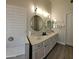 Double vanity bathroom with updated white cabinets and mirrors at 2605 N 133Rd Ave, Goodyear, AZ 85395