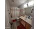 Bathroom with tub shower, vanity, and wood cabinets at 2605 N 133Rd Ave, Goodyear, AZ 85395