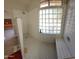 Modern bathroom with walk-in shower, glass block window, and bench at 2605 N 133Rd Ave, Goodyear, AZ 85395