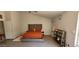 Spacious bedroom with tufted headboard and orange bedding at 2605 N 133Rd Ave, Goodyear, AZ 85395