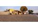 House exterior at sunset with gravel landscaping and tree at 2605 N 133Rd Ave, Goodyear, AZ 85395