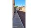 Landscaped side yard with a storage shed and concrete walkway at 2605 N 133Rd Ave, Goodyear, AZ 85395