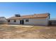 The back of the home has sliding glass doors, a concrete patio and desert landscaping at 3222 W Wagoner Rd, Phoenix, AZ 85053