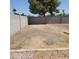 Spacious backyard featuring a large, flat dirt area, bordered by block walls and desert landscaping at 3222 W Wagoner Rd, Phoenix, AZ 85053